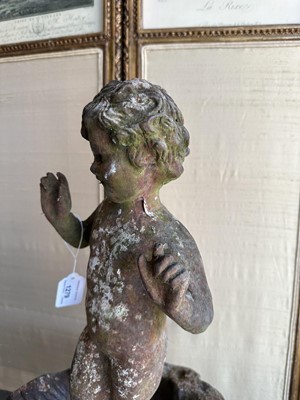 Lot 1279 - Antique cast iron bird bath mounted with a putto standing with a shell, a bird to the rim, 56cm high