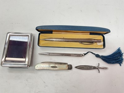 Lot 1114 - Victorian silver and mother of pearl fruit knife, silver sword bookmark, silver miniature photograph frame, silver pencil and silver yard o led pencil (5)