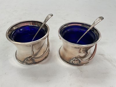 Lot 1115 - Pair of Edwardian Art Nouveau silver salts with blue glass liners