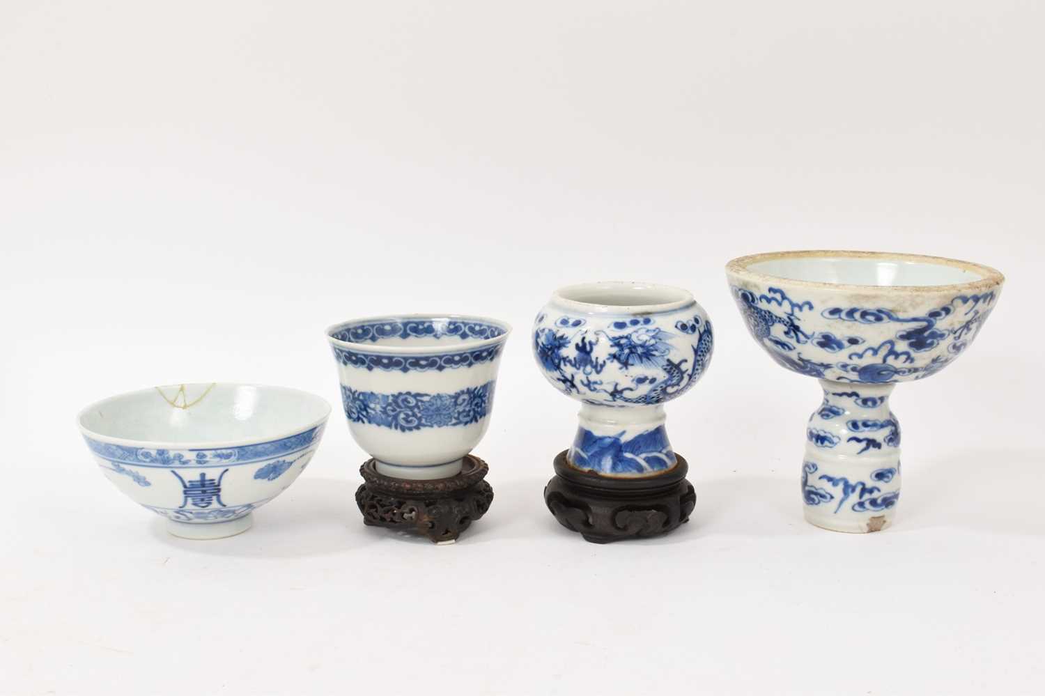 Lot 26 - Four piece of 18th and 19th century Chinese blue and white porcelain, including a candlestick / oil lamp base, vase, bowl and tea bowl
