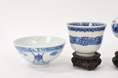 Lot 26 - Four piece of 18th and 19th century Chinese blue and white porcelain, including a candlestick / oil lamp base, vase, bowl and tea bowl