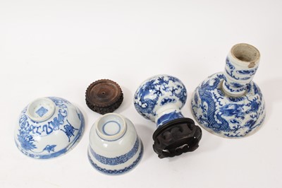 Lot 26 - Four piece of 18th and 19th century Chinese blue and white porcelain, including a candlestick / oil lamp base, vase, bowl and tea bowl