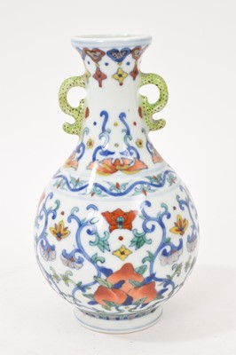 Lot 41 - Chinese porcelain twin-handled vase, 20th century decorated in the Doucai style, Qianlong seal mark to base