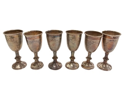 Lot 1054 - Set of six silver Jewish Kiddush cups with engraved floral wreath decoration (London 1927)