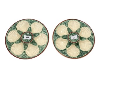 Lot 403 - Pair of French majolica oyster plates with basket weave moulding, painted green and cream, 24cm diameter