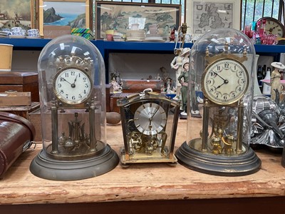 Lot 22 - Two German torsion clocks under glass domes, and another clock (3)