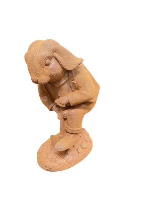 Lot 406 - Contemporary metal garden ornament in the form of a rabbit digging with a spade, 25.5cm in height.