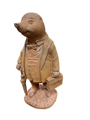 Lot 407 - Contemporary metal garden ornament in the form of a badger in a waist coat, 28cm in height.