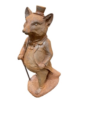 Lot 408 - Contemporary metal garden ornament in the form of a fox with a walking cane, 27.5cm in height.