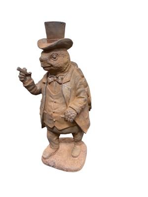 Lot 409 - Contemporary metal garden ornament in the form of a tortoise in a top hat, 28.5cm in height.
