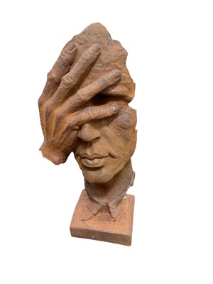Lot 417 - Contemporary metal sculpture of a hand and face, 29cm in overall height.