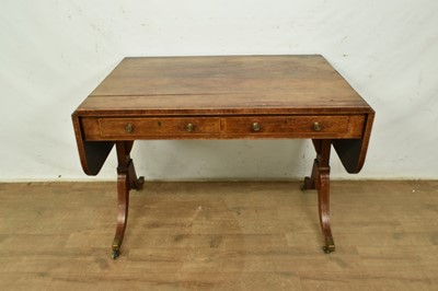 Lot 1368 - Regency rosewood sofa table with twin drawers, rounded drop flaps, on splayed legs and brass capped castors, 153cm wide overall