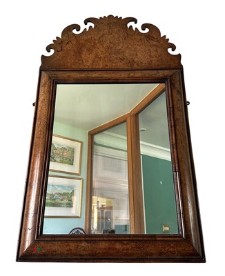 Lot 1366 - William & Mary style burr walnut framed cushion mirror with arched and carved inlaid frieze, 96cm x 56cm