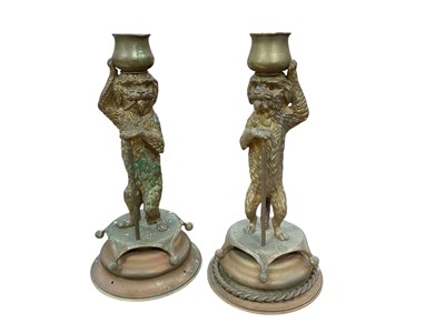 Lot 432 - Pair of amusing early 20th century gilt metal novelty candlesticks, modelled as dogs standing on their hind legs and smoking cigars, each 20.5cm in overall height.