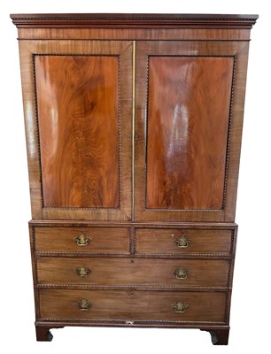Lot 1361 - George III mahogany linen press, twin panelled doors enclosing five slides above two short and two long drawers, on bracket feet