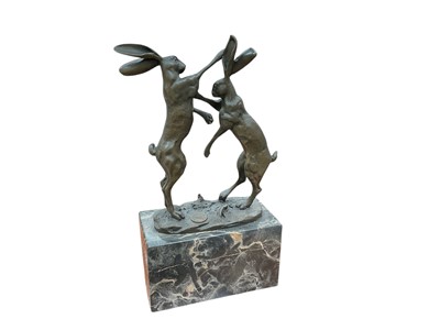 Lot 435 - Contemporary French bronze sculpture of boxing hares, raised on a marble base, 23cm in overall height.