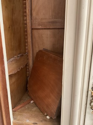 Lot 1353 - An impressive antique rococo revival wardrobe, the central mirrored doors enclosing five flanked by two cupboards, decorated with putti and foliate trailing decoration highlighted in gilt, on sc...