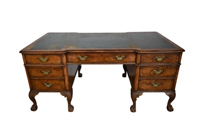 Lot 1357 - Early 20th century walnut desk, the leather-lined top above an arrangement of seven drawers, on carved cabriole legs and claw and ball feet