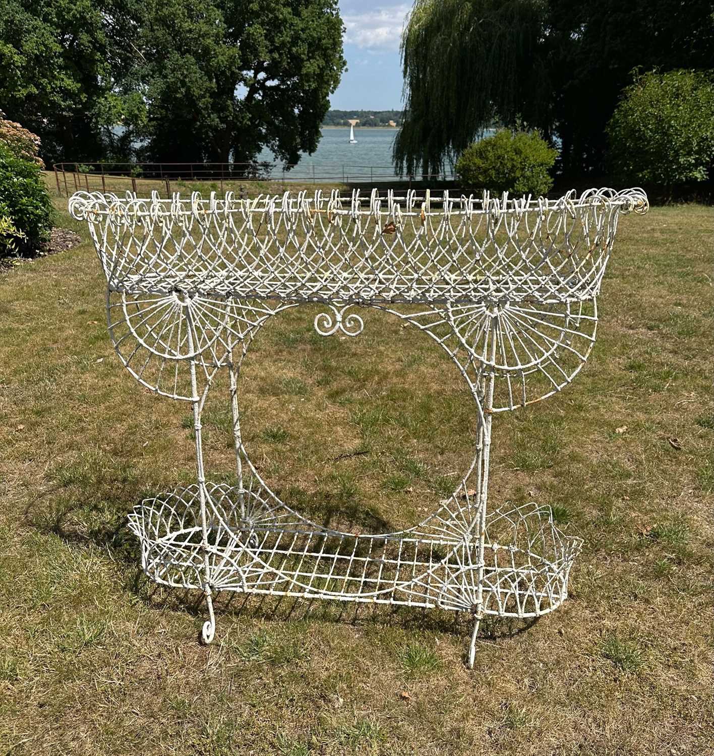 Lot 1370 - Victorian-style white painted wire work two tier plant stand, 107cm wide x 30cm deep x 93cm high