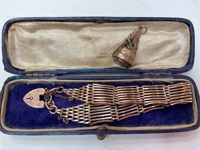 Lot 1108 - Yellow metal Masonic compass fob and gold plated gate bracelet with 9ct gold padlock clasp (2)