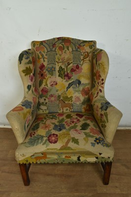 Lot 1300 - George III style wing armchair with elaborate folk art needlework tapestry upholstery.