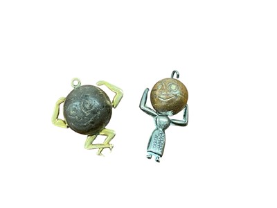 Lot 740 - Two scarce First World War lucky 'Touch Wud (Touch Wood) / Fums Up' charms, one with 9ct gold mounts and the other with silver mounts (2)