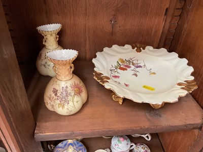 Lot 84 - Pair of Royal Worcester blush ivory vases painted with flowers, model 1663, and a dish with scrollwork feet (3)