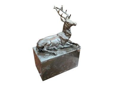 Lot 459 - Contemporary abstract bronzed metal sculpture in the form of a seated stag, raised on a marble base, 17.5cm in overall height.