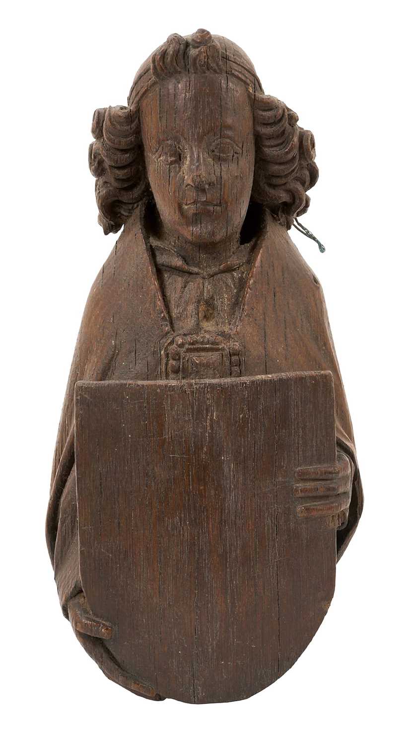 Lot 655 - Ecclesiastical carved oak roof boss, in the form of a saint, holding a shield, possibly mediaeval, 28cm high