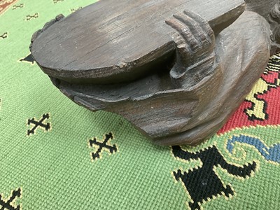 Lot 655 - Ecclesiastical carved oak roof boss, in the form of a saint, holding a shield, possibly mediaeval, 28cm high