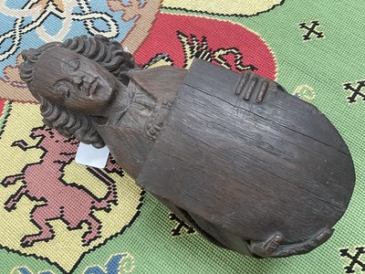 Lot 655 - Ecclesiastical carved oak roof boss, in the form of a saint, holding a shield, possibly mediaeval, 28cm high