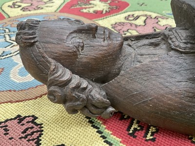 Lot 655 - Ecclesiastical carved oak roof boss, in the form of a saint, holding a shield, possibly mediaeval, 28cm high