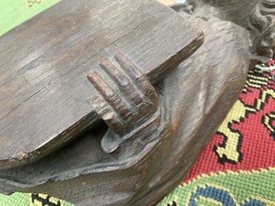 Lot 655 - Ecclesiastical carved oak roof boss, in the form of a saint, holding a shield, possibly mediaeval, 28cm high
