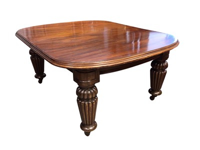 Lot 1337 - Very large mahogany extending dining table, the rounded rectangular top on massive fluted legs and castors, to include four additional leaves, 136cm wide with 158cm long, extending to approximat...