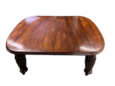 Lot 1337 - Very large mahogany extending dining table, the rounded rectangular top on massive fluted legs and castors, to include four additional leaves, 136cm wide with 158cm long, extending to approximat...