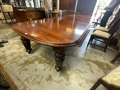 Lot 1337 - Very large mahogany extending dining table, the rounded rectangular top on massive fluted legs and castors, to include four additional leaves, 136cm wide with 158cm long, extending to approximat...