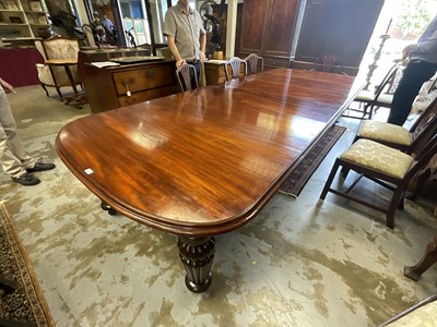 Lot 1337 - Very large mahogany extending dining table, the rounded rectangular top on massive fluted legs and castors, to include four additional leaves, 136cm wide with 158cm long, extending to approximat...