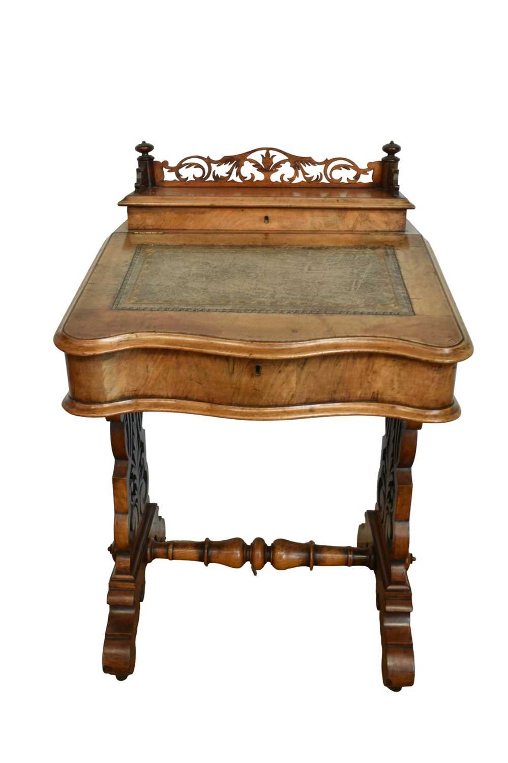 Lot 1338 - Victorian walnut desk, with pierced gallery over hinged stationery compartment and leather inset slope enclosing fitted interior of drawers and pigeon holes, raised on pierced ends and splayed s...
