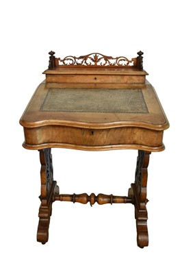 Lot 1338 - Victorian walnut desk, with pierced gallery over hinged stationery compartment and leather inset slope enclosing fitted interior of drawers and pigeon holes, raised on pierced ends and splayed s...