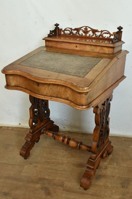 Lot 1338 - Victorian walnut desk, with pierced gallery over hinged stationery compartment and leather inset slope enclosing fitted interior of drawers and pigeon holes, raised on pierced ends and splayed s...