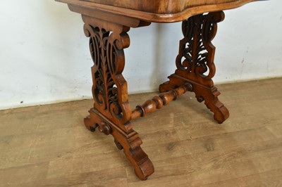 Lot 1338 - Victorian walnut desk, with pierced gallery over hinged stationery compartment and leather inset slope enclosing fitted interior of drawers and pigeon holes, raised on pierced ends and splayed s...