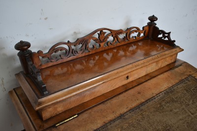 Lot 1338 - Victorian walnut desk, with pierced gallery over hinged stationery compartment and leather inset slope enclosing fitted interior of drawers and pigeon holes, raised on pierced ends and splayed s...