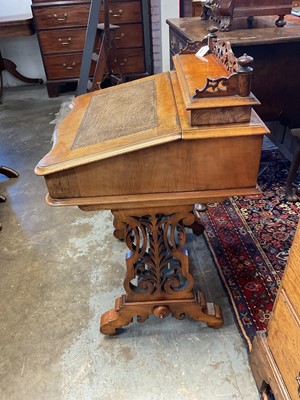 Lot 1338 - Victorian walnut desk, with pierced gallery over hinged stationery compartment and leather inset slope enclosing fitted interior of drawers and pigeon holes, raised on pierced ends and splayed s...