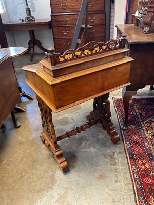 Lot 1338 - Victorian walnut desk, with pierced gallery over hinged stationery compartment and leather inset slope enclosing fitted interior of drawers and pigeon holes, raised on pierced ends and splayed s...