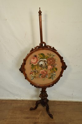 Lot 1339 - Elaborate early Victorian carved rosewood pole screen, with circular glazed bead embroidered foliate banner, adjusting on knopped and carved column and splayed carved tripod base, 155cm high