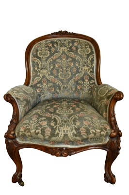 Lot 1342 - Victorian walnut framed armchair, with foliate carved frame, raised on castors