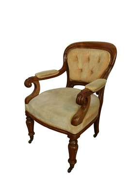Lot 1345 - William IV mahogany library chair, with button upholstered back and seat and carved pad arms, raised on lappet carved supports and castors