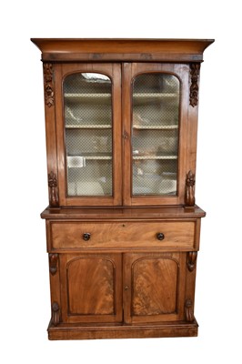 Lot 1347 - Early Victorian mahogany secretaire bookcase with concave cornice and enclosed above by glazed doors, with fitted fall-front secretaire drawer and cupboards below on...