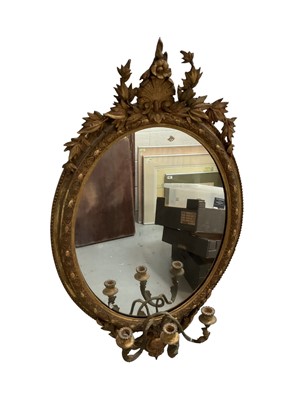 Lot 1351 - Victorian gilt girandole mirror, with oval plate and within moulded frame with laurel cresting and three scroll candle arms below, 100 x 58cm