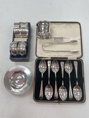 Lot 1125 - Cased set of six silver teaspoons, five silver napkin rings, pair of silver sugar tongs and a silver Armada dish